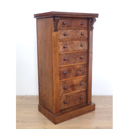 1042 - A Victorian walnut Wellington Chest of seven drawers with turned knob handles, 21in wide