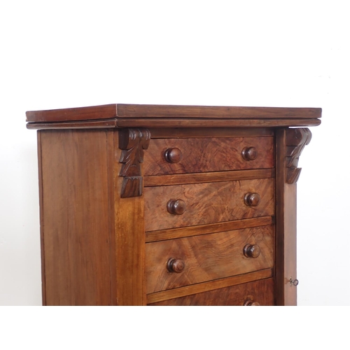 1042 - A Victorian walnut Wellington Chest of seven drawers with turned knob handles, 21in wide