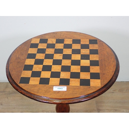 1043 - A Victorian walnut circular Games Table with inlaid chessboard top on baluster turned column and tri... 