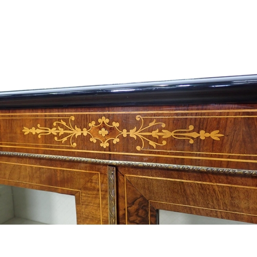 1045 - A Victorian walnut and ebonized Cabinet with pair of plain glazed doors having satinwood stringing a... 