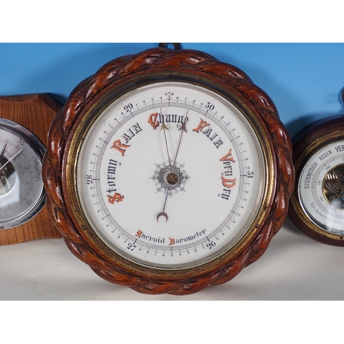 1063 - An oak rope twist cased circular aneroid Barometer, 9in, and two other small aneroid Barometers, one... 