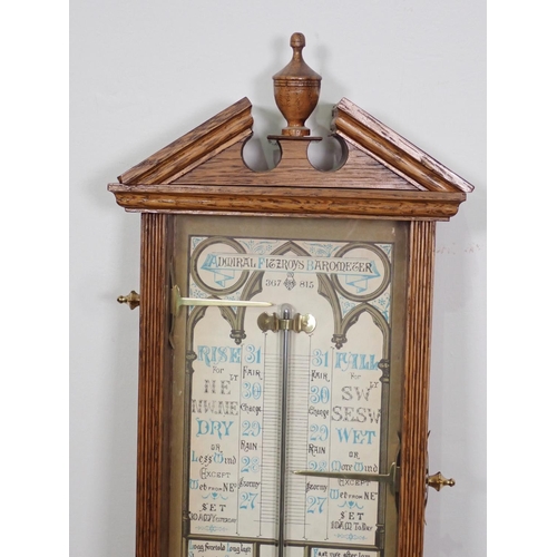 1068 - A 20th Century oak cased Admiral Fitzroy Barometer with broken arch pediment and turned finial, 3ft ... 