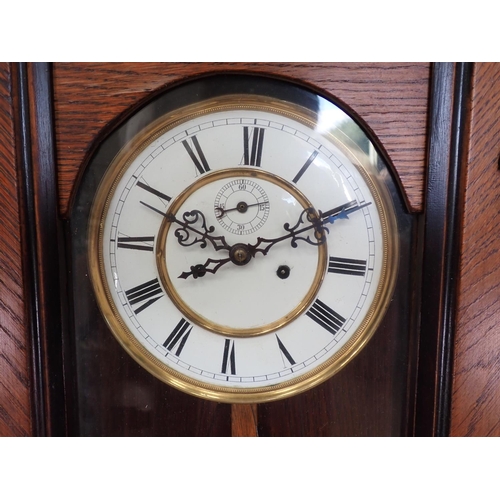 1072 - A 19th Century Vienna Wall Clock with white enamel dial, two train weight driven movement, the glaze... 