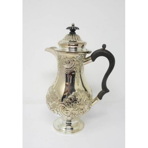807 - A Victorian silver Hot Water Jug with floral embossing and scroll handle, London 1896