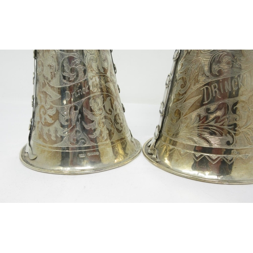 826 - A pair of Dutch silver Figural Stirrup Cups in the renaissance style, import marks London 1891
