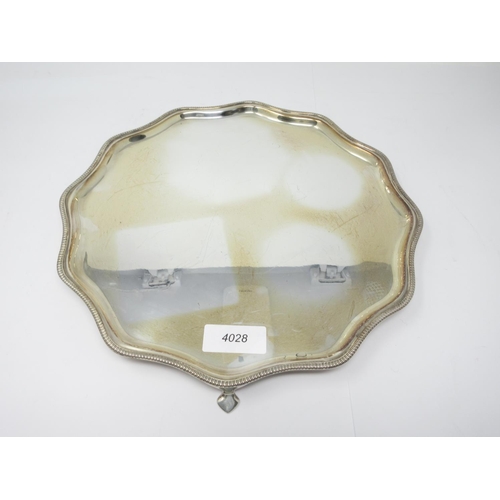 828 - A George VI silver shaped circular Salver on shaped feet, Sheffield 1937, 12in