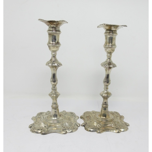 862 - A pair of George II silver cast Candlesticks with knopped stems on shaped square bases, London 1757,... 