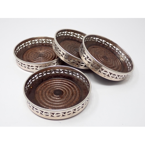 914 - A Set of four modern silver pierced circular Coasters,  Birmingham 1973, boxed