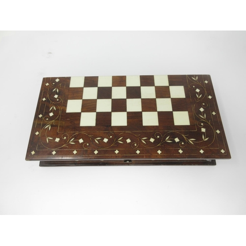 962 - A red and white carved bone Chess Set in an inlaid Indian folding case with chessboard, 12 x 6in