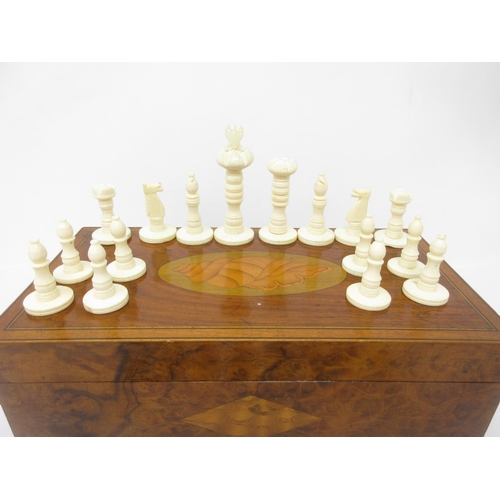 963 - A black and white Chess Set in a shell inlaid mahogany box, 9 x 4 1/2in