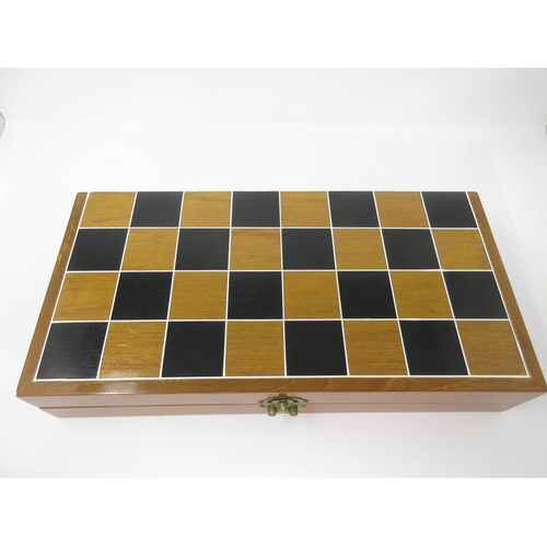 964 - A carved Chinese style Chess Set in a folding case having chessboard top 16 x 8in