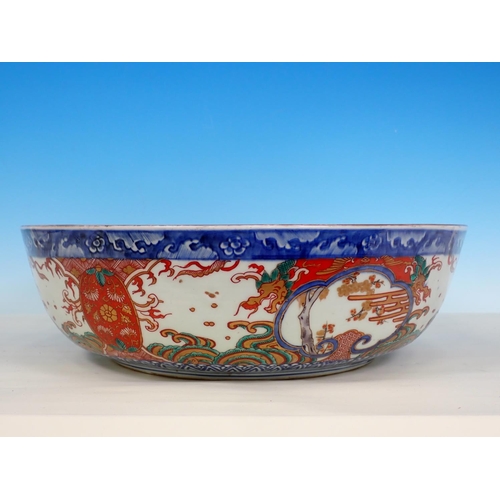 984 - A large Imari Bowl painted central fish surrounded by reserves of flowering shrubs in iron red, blue... 