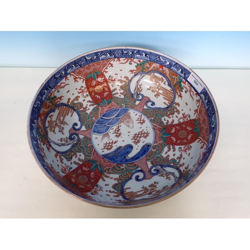 984 - A large Imari Bowl painted central fish surrounded by reserves of flowering shrubs in iron red, blue... 