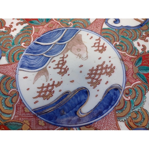 984 - A large Imari Bowl painted central fish surrounded by reserves of flowering shrubs in iron red, blue... 