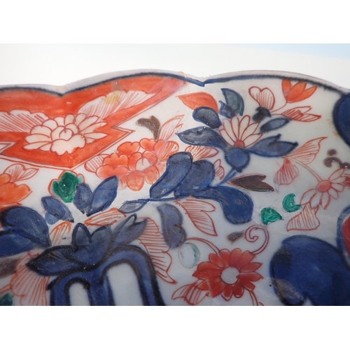 988 - An Imari Charger painted floral sprays in iron red and blue, lobed rim, 13 1/2in, restored, and a Ca... 