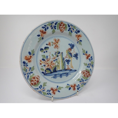 997 - A pair of Lambeth polychrome Delft Plates painted parrot on flowering branch, 9in and a similar Plat... 