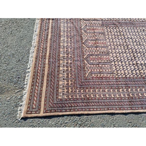 10 - An Indian Carpet, of multi-bordered design, with row of arches alongside four panels with repeating ... 