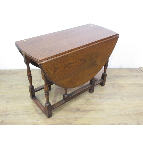 101 - An oak Gateleg Table with oval top on baluster turned supports and squared stretchers, 3ft 6in