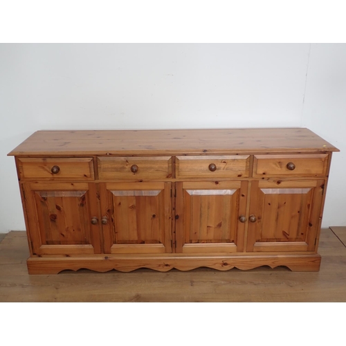 115 - A pine Dresser Base fitted four drawers above four cupboard doors, 6ft W x 2ft 7in H