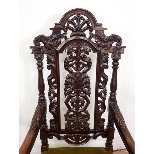 127 - A pair of elaborately carved Elbow Chairs with arched backs, stuff over seats on carved and turned s... 