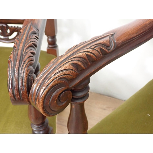 127 - A pair of elaborately carved Elbow Chairs with arched backs, stuff over seats on carved and turned s... 