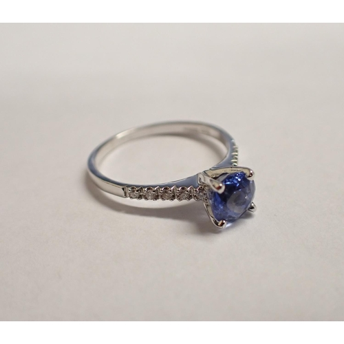 153 - A Ceylon Sapphire and Diamond Ring claw-set round mixed-cut sapphire, 0.60cts, between brilliant-cut... 