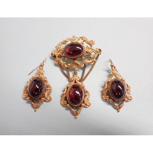 170 - A Victorian style Garnet Brooch the openwork plaque set oval cabochon suspending drop set another ca... 