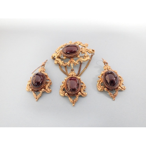 170 - A Victorian style Garnet Brooch the openwork plaque set oval cabochon suspending drop set another ca... 