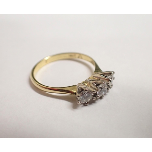 174 - A Diamond three stone Ring claw-set brilliant-cut stones, stamped 18ct, ring size N 1/2