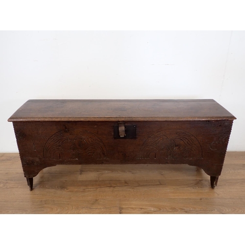 18 - A 17th Century oak Sword Chest with moulded hinged top and carved front, 4ft 2in W