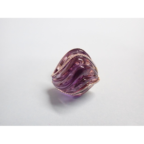 182 - An Amethyst and Diamond Cocktail Ring the carved ripple effect amethyst set two rows of brilliant-cu... 