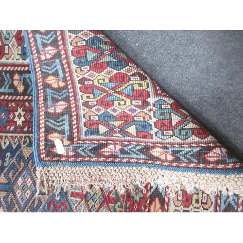 2 - A small old bordered Kashkai type Rug with central field of guls with latch hooks on blue and red gr... 