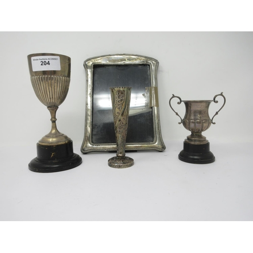 204 - A Victorian silver Spill Vase with scroll design, London 1888, two small silver Trophies and a Photo... 