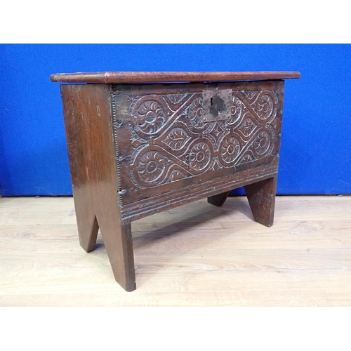 303A - A small antique oak Coffer with hinged cover and carved front, 2ft 1in W