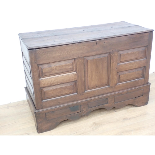 305 - An antique oak Coffer with hinged top, panelled front above dummy drawers, 4ft 5in W