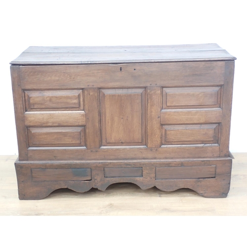 305 - An antique oak Coffer with hinged top, panelled front above dummy drawers, 4ft 5in W