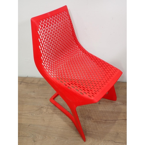 312 - A set of Myto red plastic Chairs with pierced design