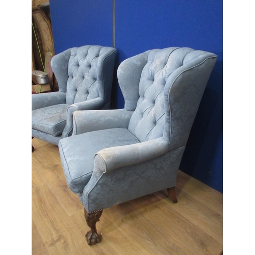 323 - A pair of Georgian style button upholstered wing back Armchairs with carved squat cabriole supports ... 