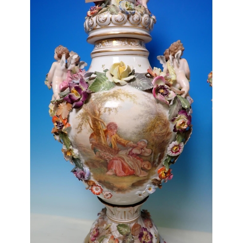 335 - A pair of Continental floral and cherub encrusted lidded Vases, A/F