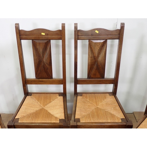 421 - A set of four oak Dining Chairs with rush seats and turned supports