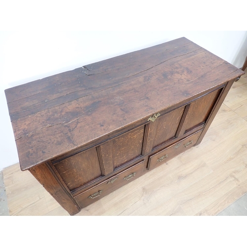 471 - An antique oak Mule Chest with hinged cover, panelled front above two drawers, 4ft 7in W