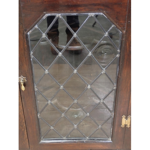 497 - An antique oak hanging Corner Cupboard with single glazed door, 2ft 10in H