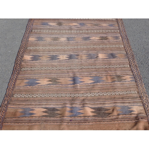 55 - A Kelim Rug with multi borders and all over rows of stylised designs, 9ft 7in x 4ft 6in (moth damage... 