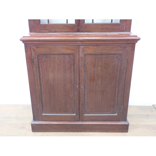 590 - A tall mahogany Bookcase fitted pair of astragal glazed doors above a pair of cupboard doors on plin... 