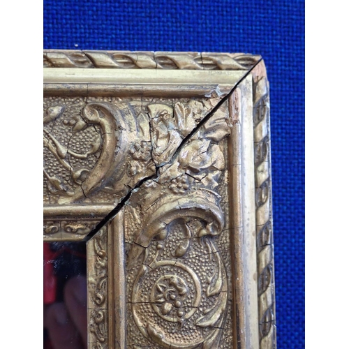 597 - A gilt framed Wall Mirror with designs of scrolls and foliate detail, 2ft 6in x 1ft 11in