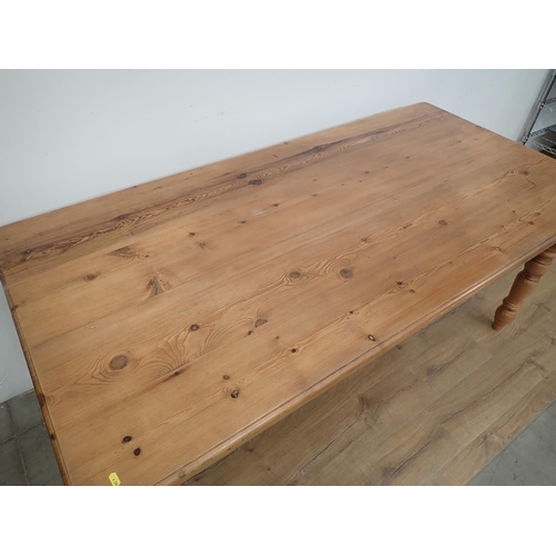 60 - A large pine Dining Table and eight Chairs, the table with turned supports, 6ft L x 3ft W