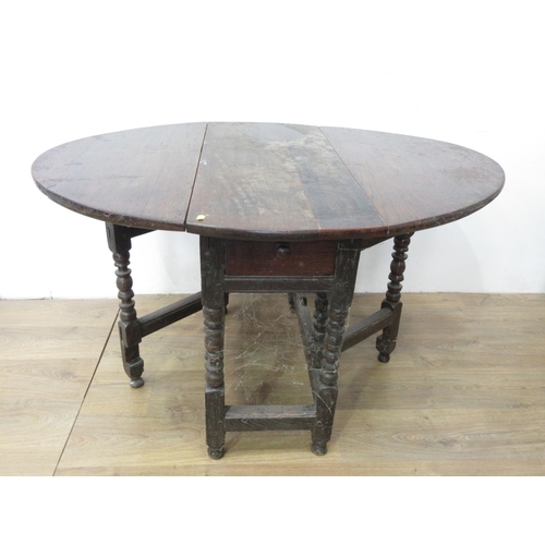 89 - An antique oak Gateleg Table with oval top, fitted frieze drawer on turned supports and squared stre... 