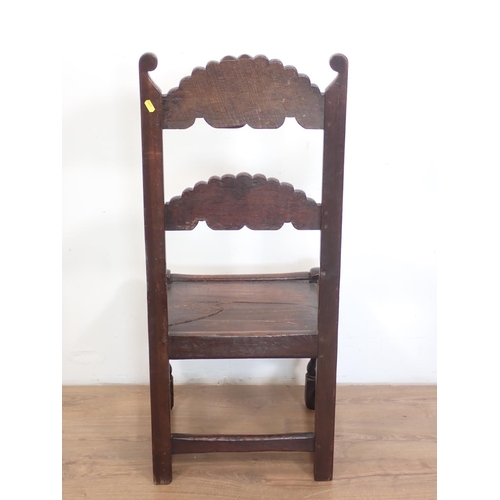 94 - An antique oak Derbyshire single chair with carving to the back, solid seat, turned and squared supp... 