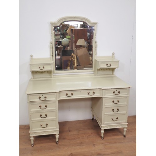 401 - A large white painted Dressing Table fitted multiple drawers on turned supports and casters, 4ft 6in... 