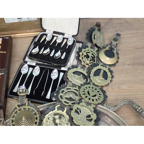 10 - Plated Teapot, various cased Cutlery, Horse Brasses on leather straps and framed motoring related Po... 